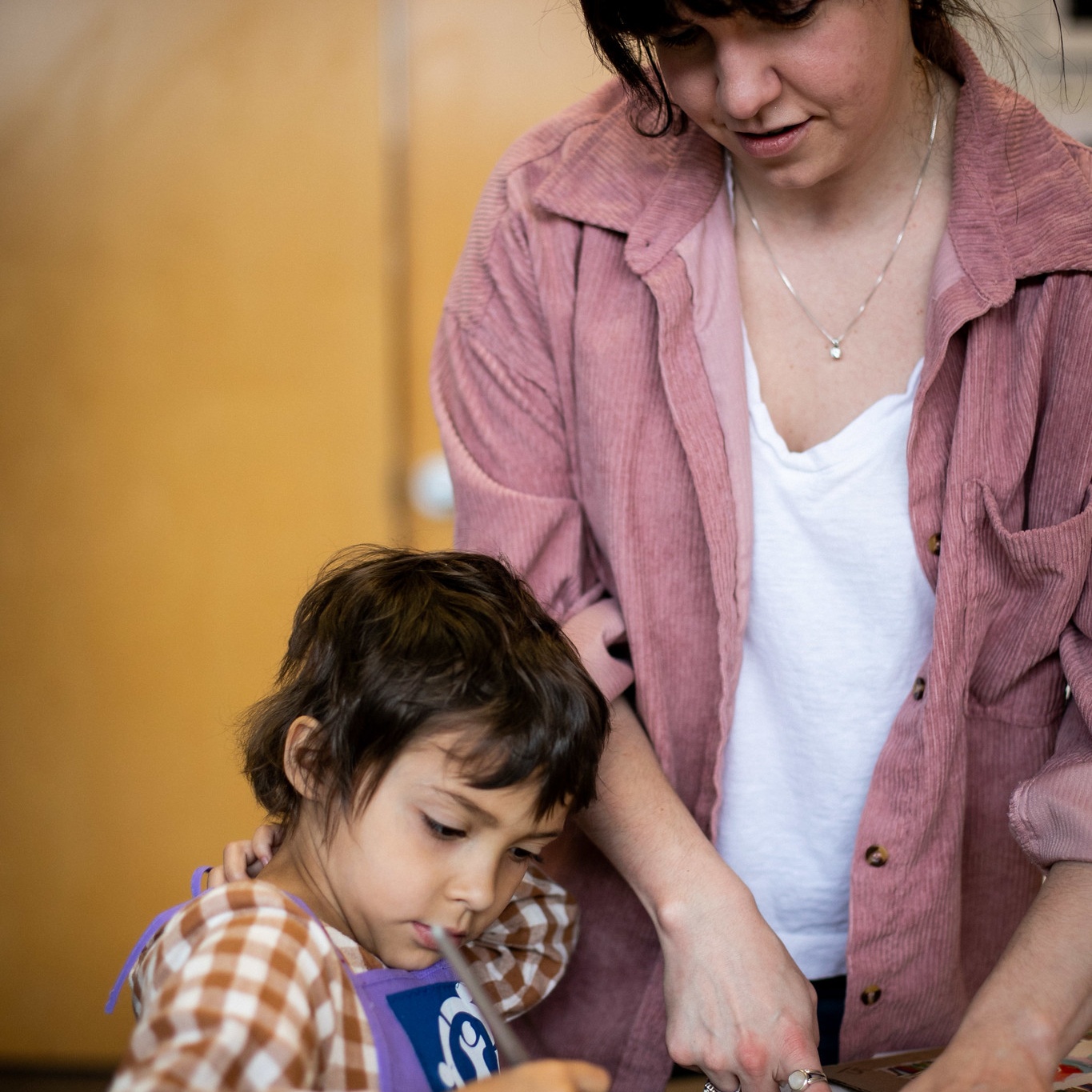 Alex working with child on art project